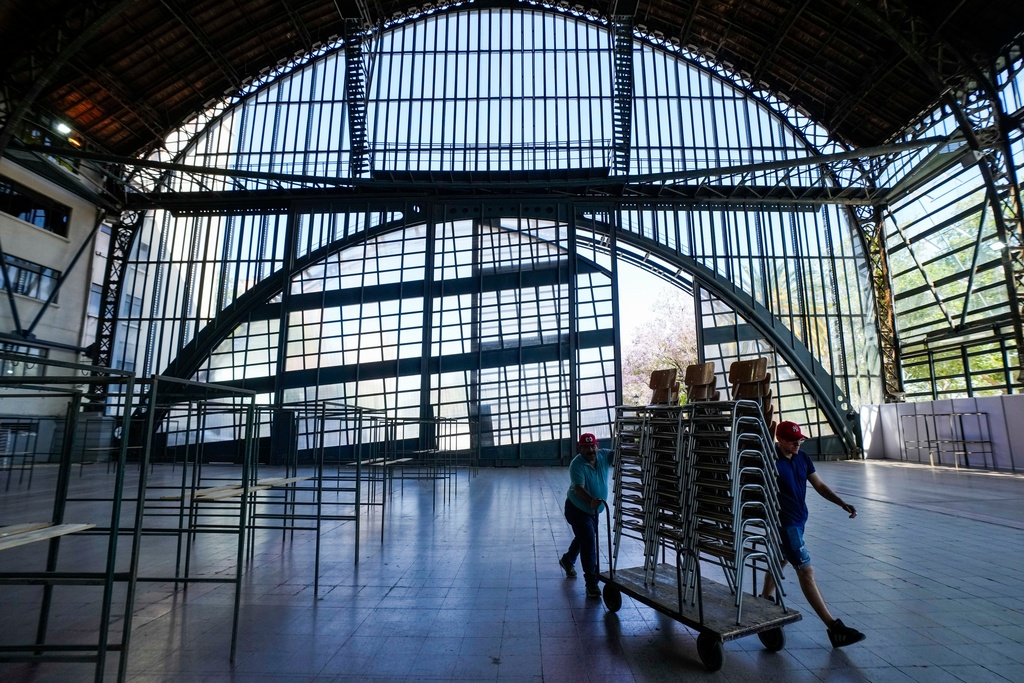 Electoral workers prepare the old Mapocho train station, now a cultural center, to be used as a polling station for the general election in Santiago, Chile, Friday, Nov. 14, 2025. (AP Photo/Esteban Felix)