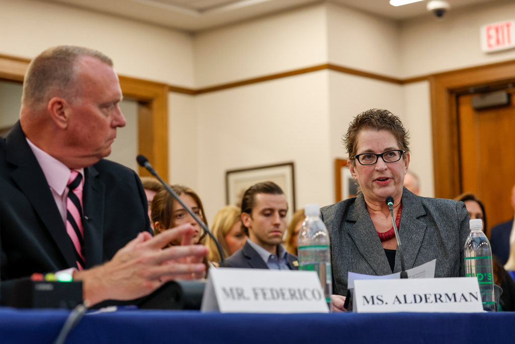 Steve Federico, left, looks on as Mia Alderman testifies about the murder of her granddaughter Mary Santina Collins during the House Judiciary Subcommittee on Oversight holds a field hearing on violent crime in Charlotte, N.C., Monday, Sept. 29, 2025. (AP Photo/Nell Redmond)