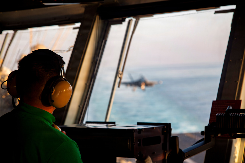 This image provided by U.S. Central Command shows a Navy sailor observing flight operations aboard the USS Abraham Lincoln (CVN 72)) in support of Operation Epic Fury, on Saturday, Feb. 28, 2026. (U.S. Navy via AP)