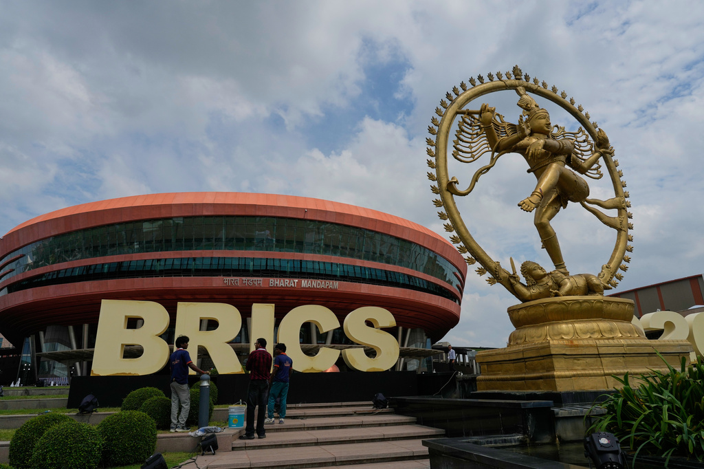 Workers apply finishing touches to a BRICS sign ahead of the summit at Bharat Mandapam in New Delhi, India, Saturday, Sept. 12, 2026. (AP Photo/Manish Swarup)