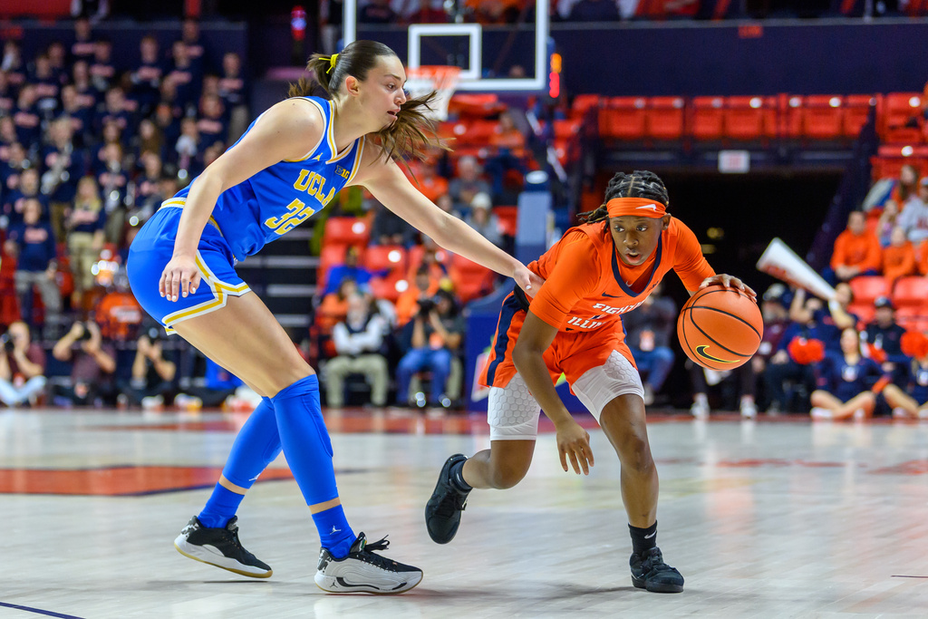 Illinois' Destiny Jackson drives for position against UCLA's Angela Dugalić during the first half of an NCAA college basketball game Wednesday, Jan. 28, 2026, in Champaign, Ill. (AP Photo/Craig Pessman)