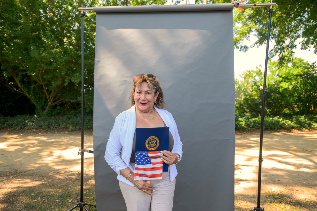 New U.S. citizen Martha Flores de Martinez, from El Salvador, poses for a portrait following a naturalization ceremony on Independence Day at George Washington's Mount Vernon, Saturday, July 4, 2026, in Alexandria, Va. (AP Photo/Rod Lamkey, Jr.)
