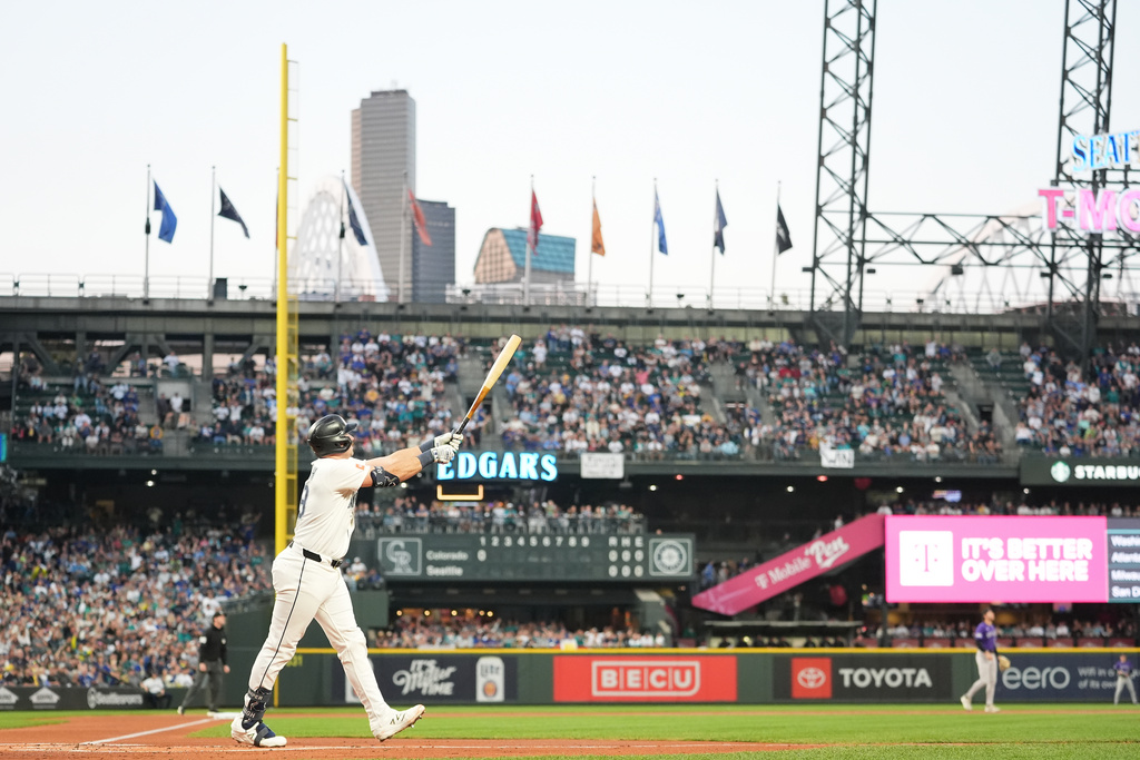Seattle Mariners' Cal Raleigh watches after hitting a solo home run during the first inning of a baseball game against the Colorado Rockies, Wednesday, Sept. 24, 2025, in Seattle. (AP Photo/Ryan Sun)