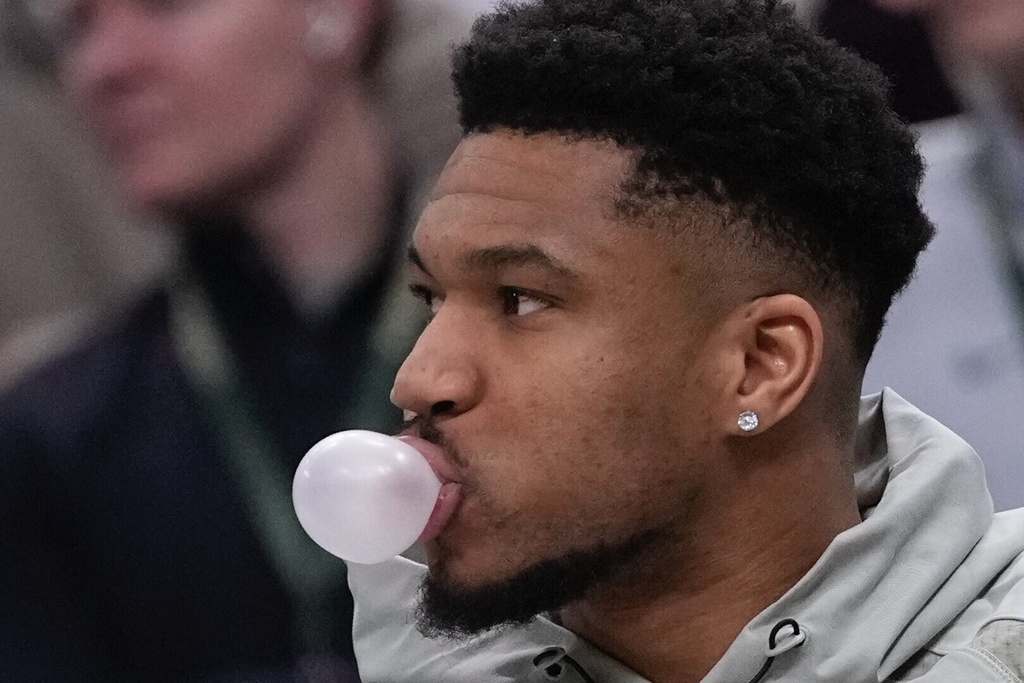 Milwaukee Bucks' Giannis Antetokounmpo blows a bubble on the bench during the first half of an NBA basketball game Tuesday, Feb. 3, 2026, in Milwaukee. (AP Photo/Morry Gash)