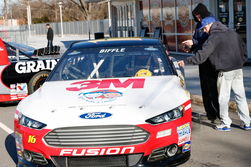 Bailey Kitchens, right, and Noah Teer look at a race car of the late Greg Biffle before a NASCAR Plane Crash Memorial memorial for him, his family and others who died in a plane crash, in Charlotte, N.C., Friday, Jan. 16, 2026. (AP Photo/Nell Redmond)