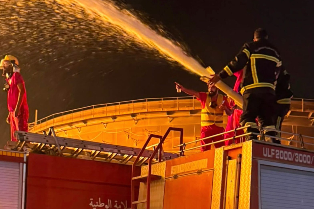 Firefighters work to contain a fire at the Zawiya oil refinery following a drone strike in Zawiya, Libya, Tuesday, Aug. 11, 2026. (Libyan Fire Department via AP)