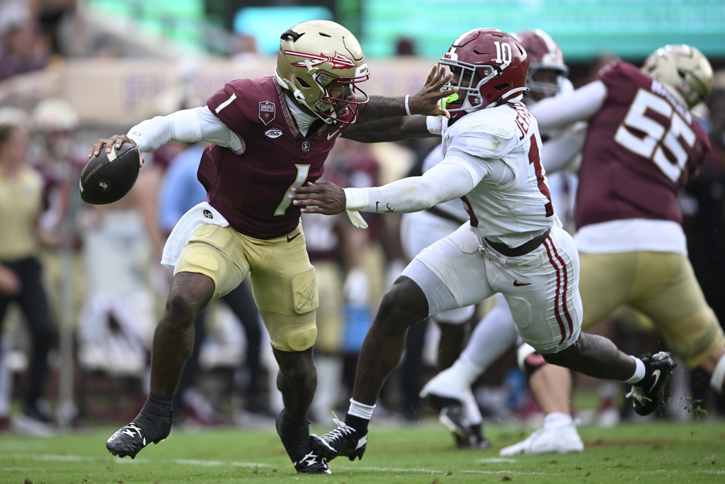 Florida State quarterback Tommy Castellanos (1) scrambles away from Alabama linebacker Justin Jefferson (10) during the second half of an NCAA college football game, Saturday, Aug. 30, 2025, in Tallahassee, Fla. (AP Photo/Phelan M. Ebenhack)