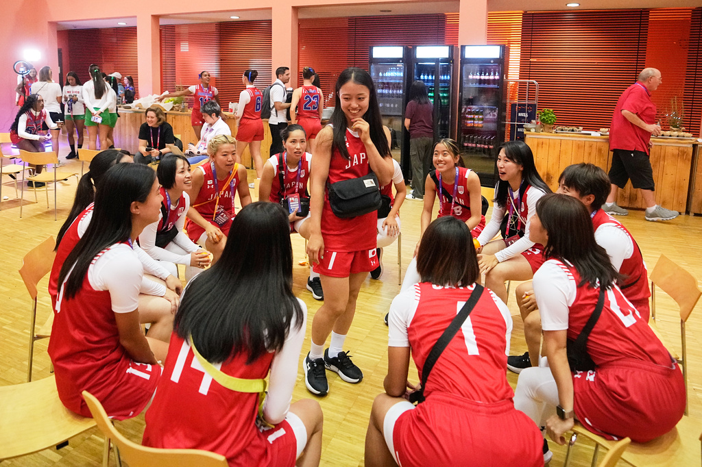 Japan's women's team have fun during the media day ahead of the Flag Football World Championships, the sports first Olympic qualifier for LA28, in Duesseldorf, Germany, Wednesday, Aug. 12, 2026. (AP Photo/Martin Meissner)
