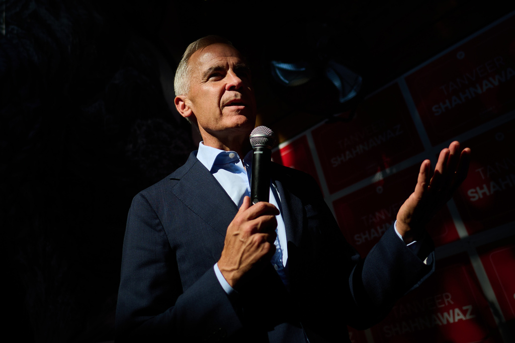 Prime Minister Mark Carney speaks at a campaign event for Liberal Party Beaches-East York byelection candidate Tanveer Shahnawaz at The Stone Lion Pub in Toronto, on Wednesday, Aug. 5, 2026. (Sammy Kogan/The Canadian Press via AP)