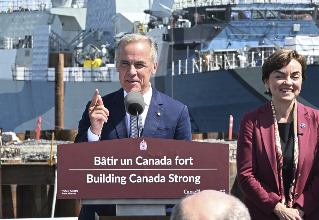 Canadian Prime Minister Mark Carney speaks at the Davie shipyard in Levis, Quebec on Monday, Aug. 24, 2026. Quebec Premier Christine Frechette, right, looks on. (Jacques Boissinot/The Canadian Press via AP)