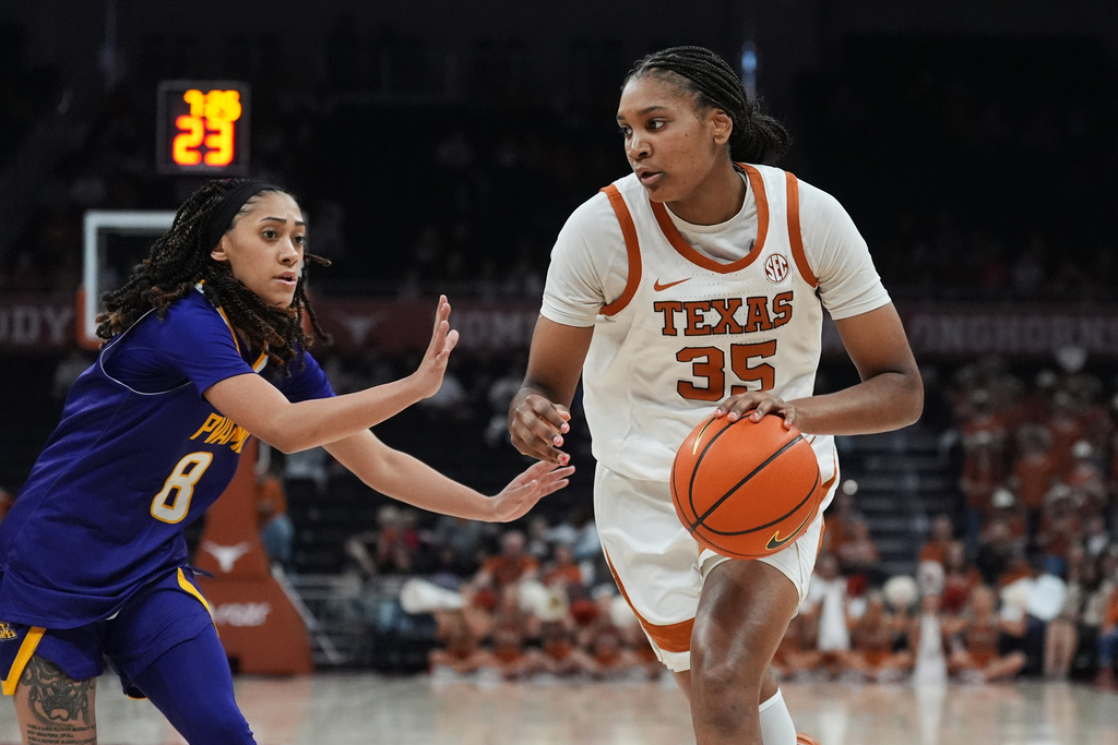Texas forward Madison Booker (35) works the ball past Prairie View A&M guard Jacque Giron (8) during the second half of an NCAA college basketball game in Austin, Texas, Sunday, Dec. 7, 2025. (AP Photo/Eric Gay)
