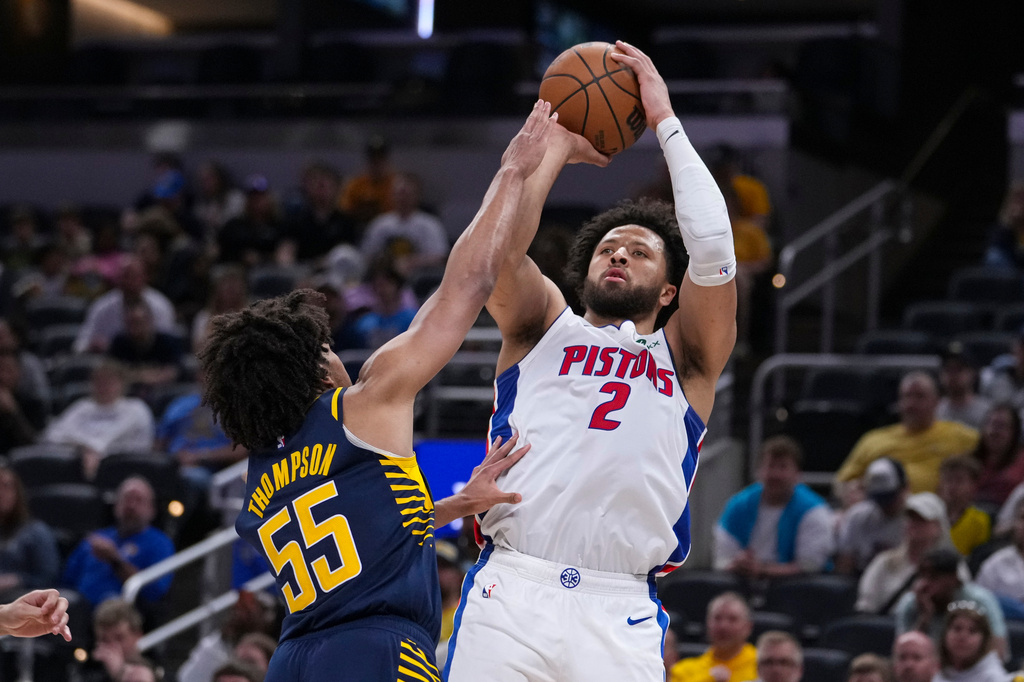 Detroit Pistons guard Cade Cunningham (2) shoots over Indiana Pacers guard Ethan Thompson (55) during the second half of an NBA basketball game in Indianapolis, Sunday, April 12, 2026. (AP Photo/Michael Conroy)