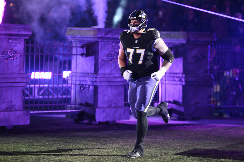 FILE - Baltimore Ravens guard Daniel Faalele (77) takes to the field before an NFL football game against the New England Patriots, Sunday, Dec. 21, 2025, in Baltimore. (AP Photo/Nick Wass, file)