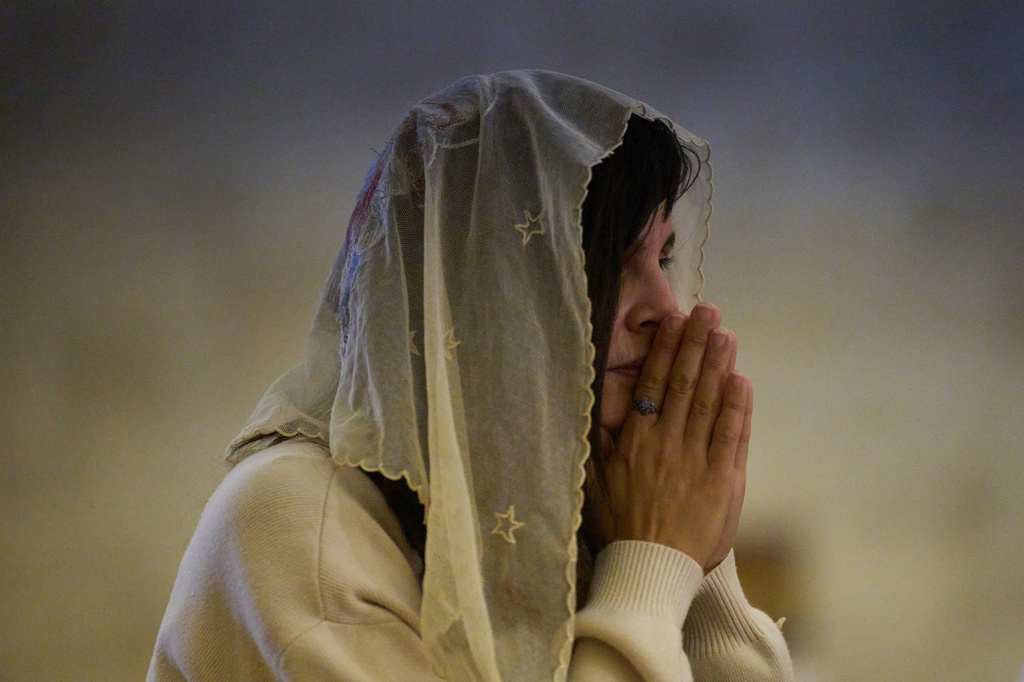 A Christian pilgrim attends a Mass in the Basilica of the Transfiguration on Mount Tabor, northern Israel, Aug. 6, 2026. (AP Photo/Ariel Schalit)