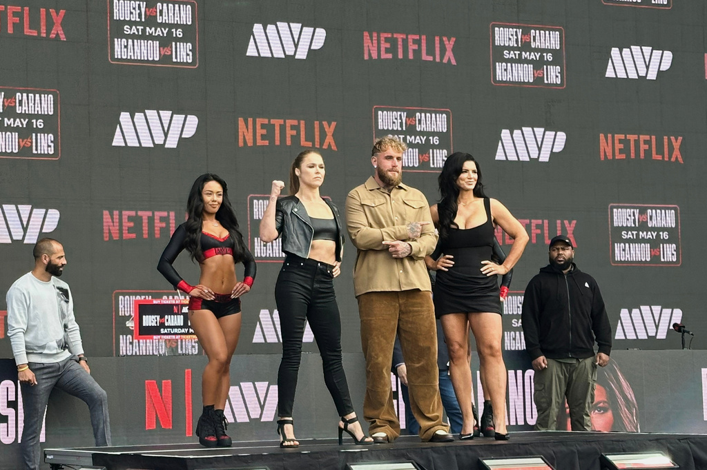 FILE - Ronda Rousey, center left, and Gina Carano, right, pose with promoter Jake Paul, center right, during a news conference, in Inglewood, Calif., March 10, 2026. (AP Photo/Greg Beacham, File)
