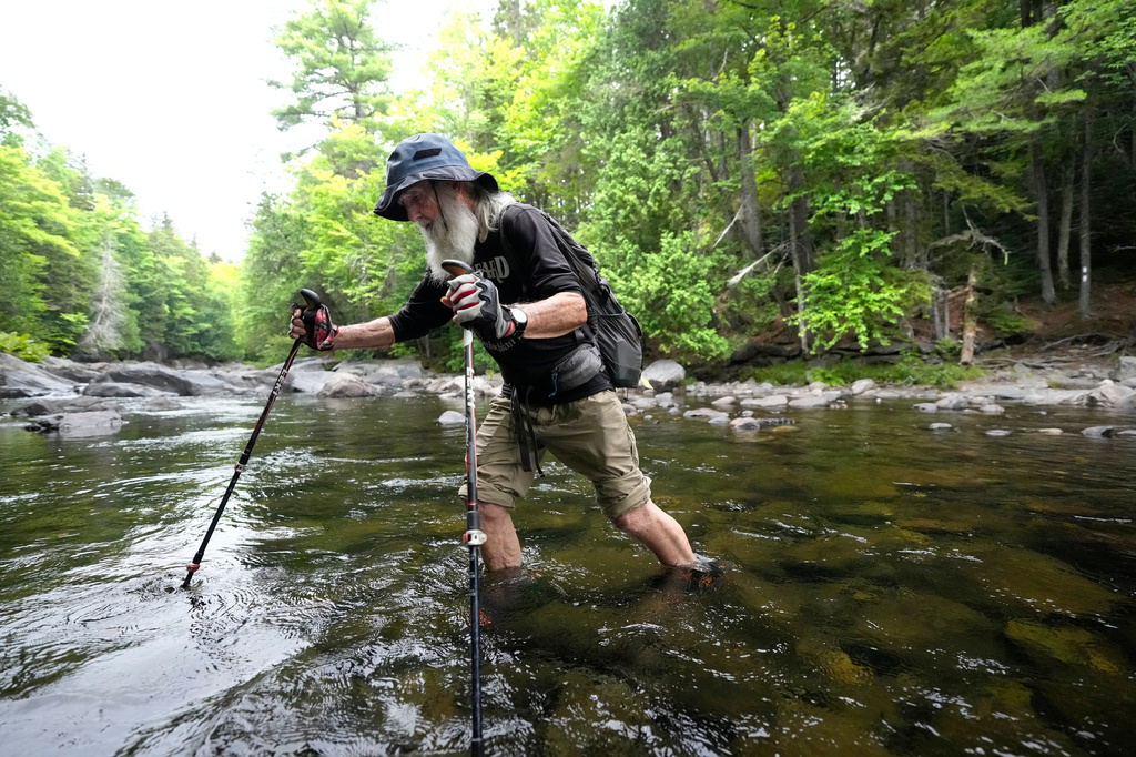 Appalachian Trail hiker Dale Sanders wades across Big Wilson Stream on the 100-Mile Wilderness north of Monson, Maine, Wednesday, July 29, 2026. (AP Photo/Robert F. Bukaty)
