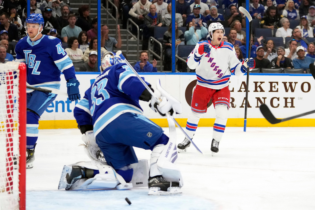 New York Rangers left wing Tye Kartye (24) celebrates after scoring past Tampa Bay Lightning goaltender Brandon Halverson (33) during the first period of an NHL hockey game Wednesday, April 15, 2026, in Tampa, Fla. (AP Photo/Chris O'Meara)