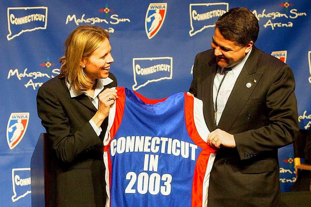 FILE - WNBA League President Val Ackerman, left, and Mohegan Tribe Tribal Chairman Mark Brown hold a basketball shirt of the type that will be worn by the WNBA team Connecticut Sun during a news conference Tuesday, Jan. 28, 2003, at the Mohegan Sun Arena in Uncasville, Conn. (AP Photo/Bob Child, File)