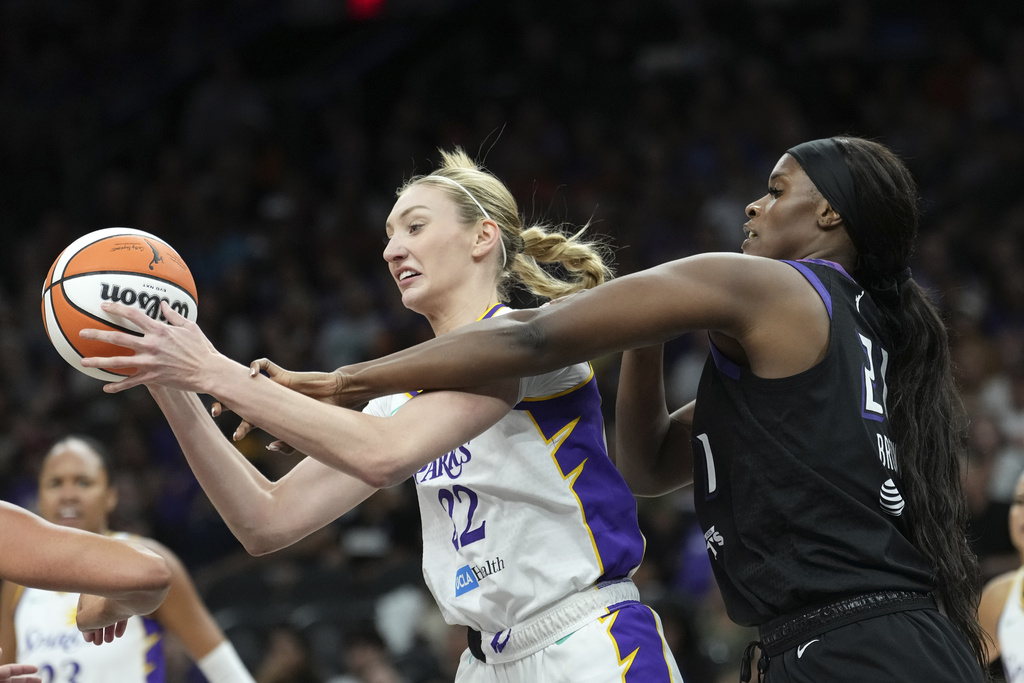 Los Angeles Sparks forward Cameron Brink, left, grabs a rebound in front of Phoenix Mercury center Kalani Brown, right, during the first half of a WNBA basketball game Tuesday, Sept. 9, 2025, in Phoenix. (AP Photo/Ross D. Franklin)