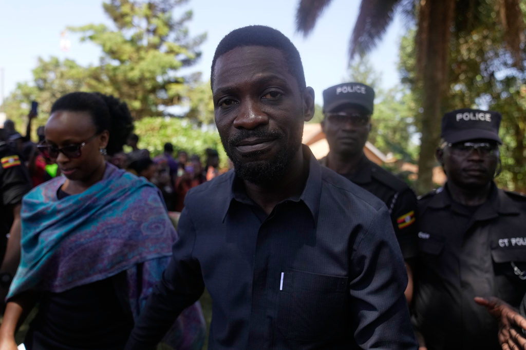 Uganda opposition presidential candidate Robert Kyagulanyi Ssentamu, famously known as Bobi Wine of the National Unity Platform (NUP), arrives with his wife to cast their votes, during the presidential election at a polling station, in Kampala, Uganda, Thursday, Jan. 15, 2026. (AP Photo/Brian Inganga)