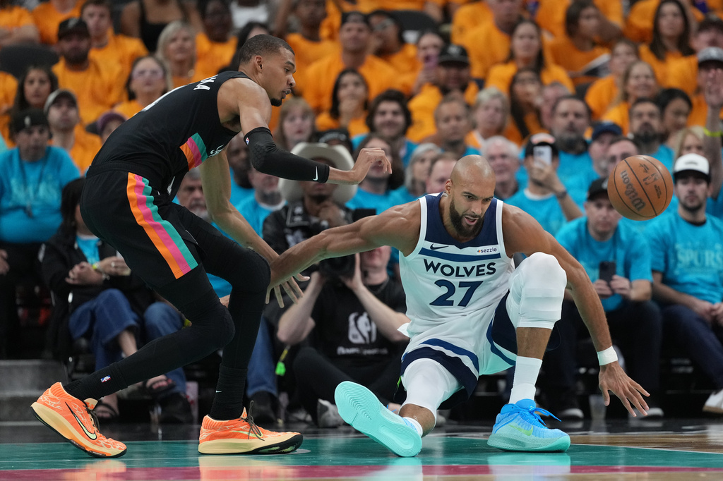 Minnesota Timberwolves center Rudy Gobert (27) loses control of the ball as San Antonio Spurs forward Victor Wembanyama (1) defends during the first half in Game 1 of a second-round NBA playoffs basketball series in San Antonio, Monday, May 4, 2026. (AP Photo/Eric Gay)
