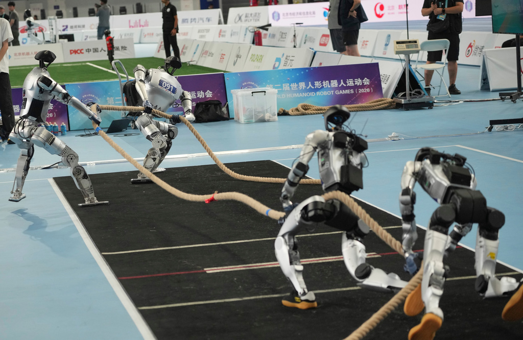 Humanoid robots compete in the tug of war during the World Humanoid Robot Games in Beijing, Tuesday, Aug. 25, 2026. (AP Photo/Achmad Ibrahim)