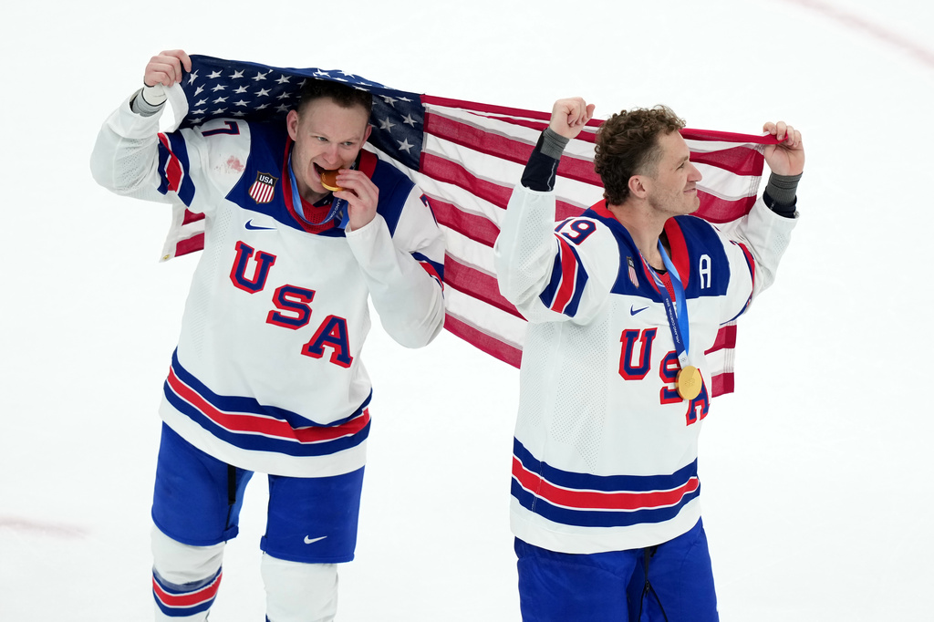 FILE - United States' Brady Tkachuk (7) and Matthew Tkachuk (19) celebrate after the United States' win over Canada in the men's ice hockey gold medal game at the 2026 Winter Olympics in Milan, Italy, Feb. 22, 2026. (AP Photo/Carolyn Kaster, File)
