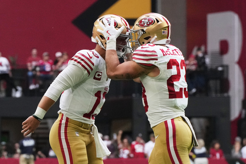 San Francisco 49ers quarterback Brock Purdy, left, and running back Christian McCaffrey celebrate after connecting on a touchdown pass against the Arizona Cardinals during the first half of an NFL football game in Glendale, Ariz., Sunday, Nov. 16, 2025. (AP Photo/Rick Scuteri)