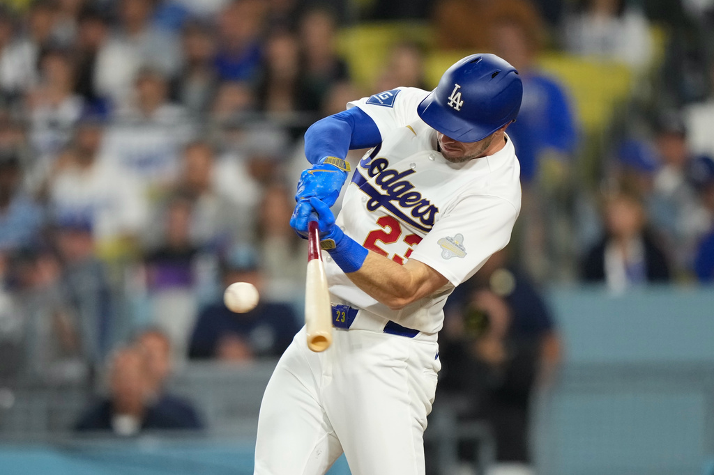 Los Angeles Dodgers' Kyle Tucker hits an RBI single during the eighth inning of a baseball game against the Arizona Diamondbacks, Friday, March 27, 2026, in Los Angeles. (AP Photo/Mark J. Terrill)