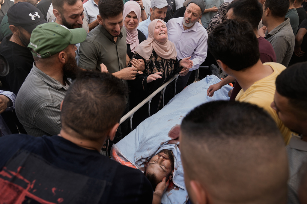 People mourn over the body of Jawad Ramadan, who, according to the Palestinian Health Ministry, was killed by Israeli forces near the village of Tell, after his body was brought to Nablus Speciality Hospital in the West Bank city of Nablus, Friday, July 24, 2026. (AP Photo/Majdi Mohammed)