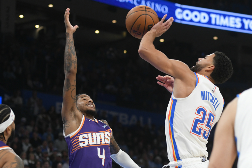 Oklahoma City Thunder guard Ajay Mitchell (25) shoots over Phoenix Suns guard Jalen Green (4) during the second half of an NBA basketball game, Monday, Oct. 26, 2026, in Oklahoma City. (AP Photo/Kyle Phillips)