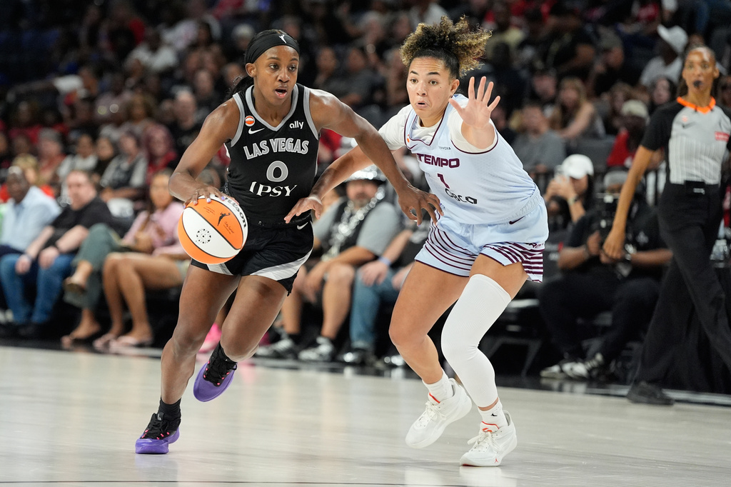 Las Vegas Aces guard Jackie Young (0) drives against Toronto Tempo guard Kiki Rice (1) during the second half of a WNBA basketball game Friday, Aug. 28, 2026, in Las Vegas. (AP Photo/John Locher)