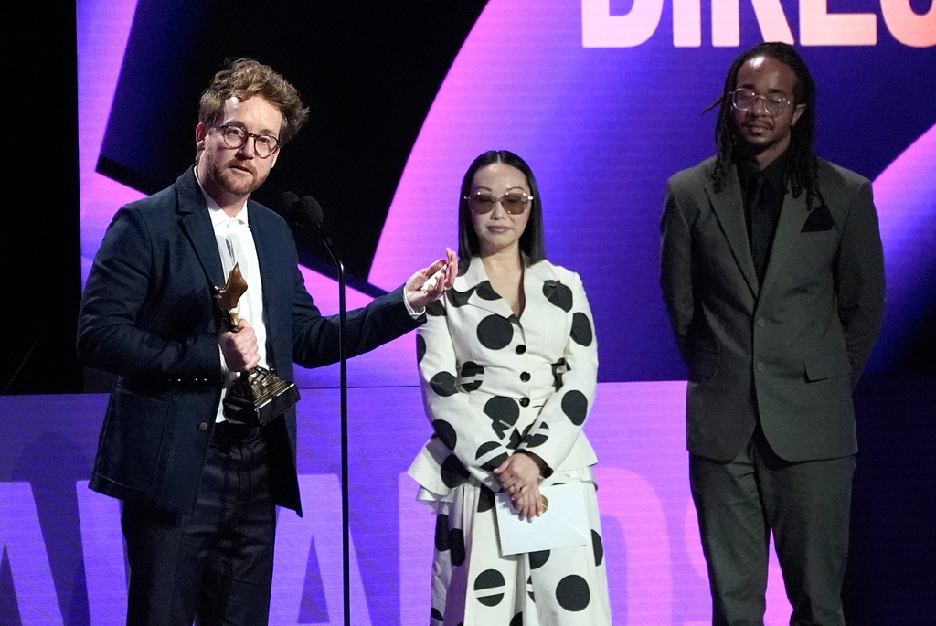 Clint Bentley accepts the award for best director for "Train Dreams" during the Film Independent Spirit Awards on Sunday, Feb. 15, 2026, at the Hollywood Palladium in Los Angeles. Lulu Wang looks on from right.(AP Photo/Chris Pizzello)