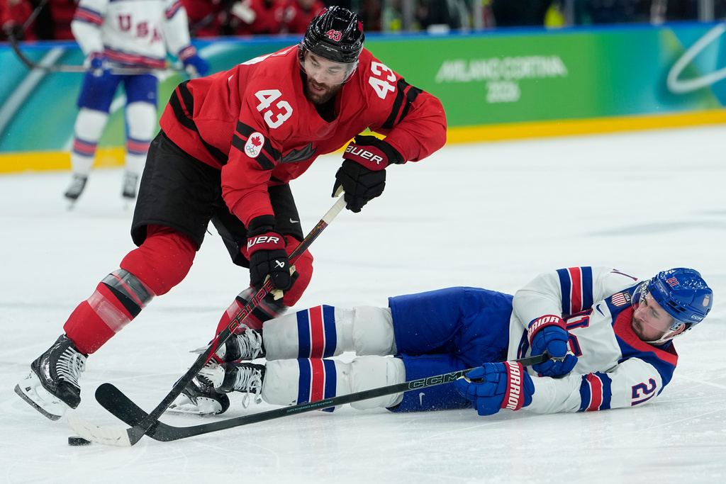 Canada's Tom Wilson (43) and United States' Dylan Larkin (21) battle for the puck during the second period of a men's ice hockey gold medal game between Canada and the United States at the 2026 Winter Olympics, in Milan, Italy, Sunday, Feb. 22, 2026. (AP Photo/Petr David Josek)