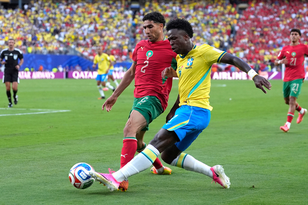 Brazil's Vinicius Junior (7) challenges for the ball with Morocco's Achraf Hakimi (2) during the World Cup Group C soccer match between Brazil and Morocco in East Rutherford, N.J., near New York, Saturday, June 13, 2026. (AP Photo/Yuki Iwanmura)