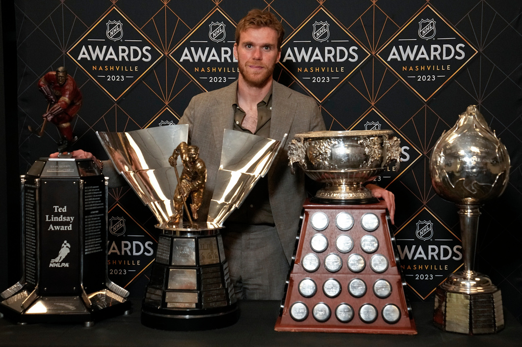 FILE - Edmonton Oilers hockey player Connor McDavid poses with the Ted Lindsey Award, the Maurice "Rocket" Richard Trophy, the Art Ross Trophy and the Hart Memorial Trophy at the NHL Awards, on June 26, 2023, in Nashville, Tenn. (AP Photo/George Walker IV, File)