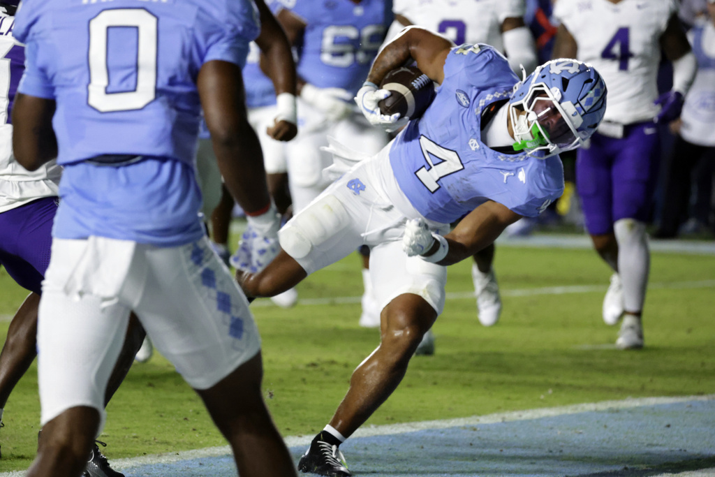 North Carolina running back Caleb Hood (4) runs for a touchdown during the first half of an NCAA college football game against TCU, Monday, Sept. 1, 2025, in Chapel Hill, N.C. (AP Photo/Chris Seward)