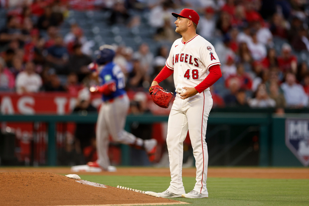 Los Angeles Angels starting pitcher Reid Detmers (48) looks on as Toronto Blue Jays' Vladimir Guerrero Jr. (27) rounds the bases after hitting a two-run home run during the third inning of a baseball game Monday, April 20, 2026, in Anaheim, Calif. (AP Photo/Caroline Brehman)