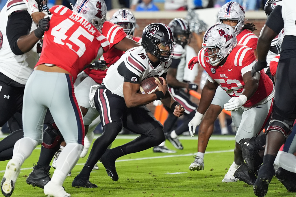 South Carolina quarterback Lanorris Sellers (16) runs past Mississippi defenders for a one-yard touchdown pass during the first half of an NCAA college football game Saturday Nov. 1, 2025, in Oxford, Miss. (AP Photo/Rogelio V. Solis)