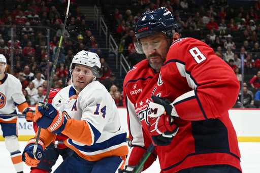 New York Islanders center Bo Horvat (14) and Washington Capitals left wing Alex Ovechkin (8) react to the flying puck during the first period of an NHL hockey game, Friday, Oct. 31, 2025, in Washington. (AP Photo/Nick Wass) New York Islanders center Bo Horvat (14) and Washington Capitals left wing Alex Ovechkin (8) react to the flying puck during the first period of an NHL hockey game, Friday, Oct. 31, 2025, in Washington. (AP Photo/Nick Wass)