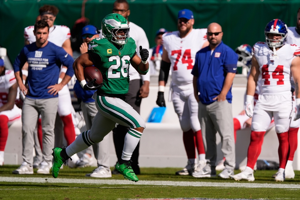 Philadelphia Eagles running back Saquon Barkley (26) runs for a touchdown during the first half of an NFL football game against the New York Giants on Sunday, Oct. 26, 2025, in Philadelphia. (AP Photo/Chris Szagola)
