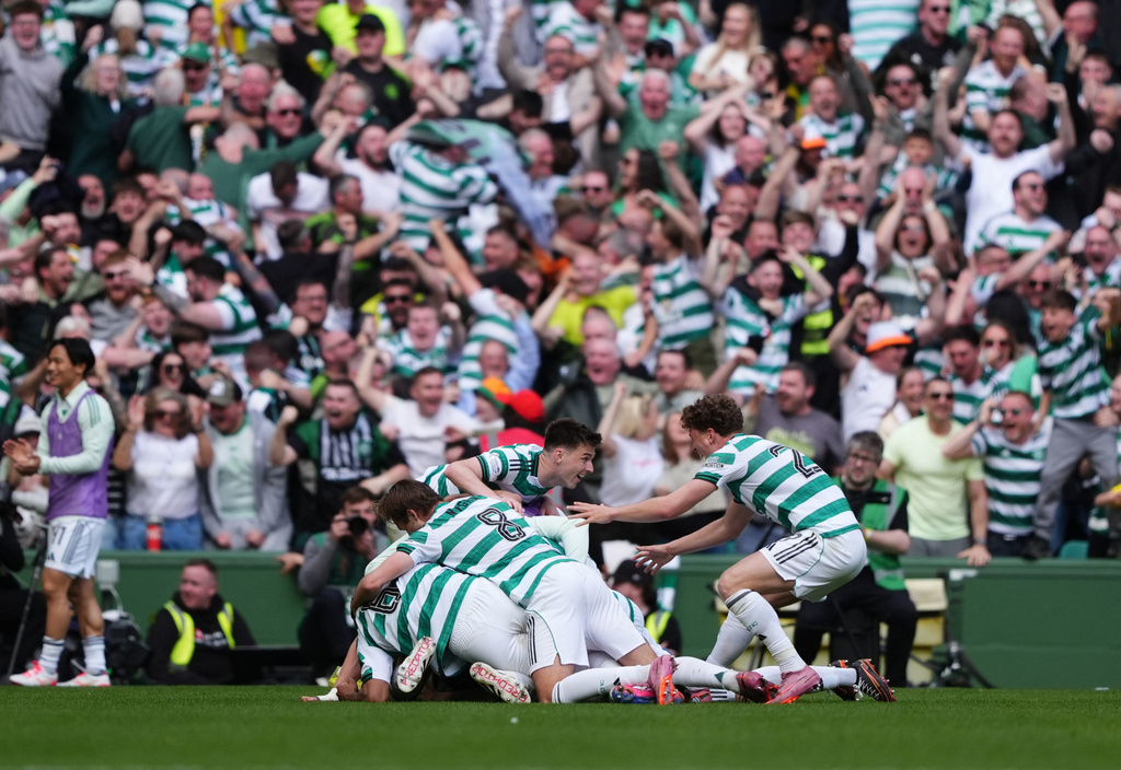 Celtic's Daizen Maeda (hidden) celebrates with team-mats after scoring their side's third goal during the Scottish Premiership soccer match between Celtic and Rangers, in Glasgow, Sunday May 10, 2026. (Steve Welsh/PA via AP)
