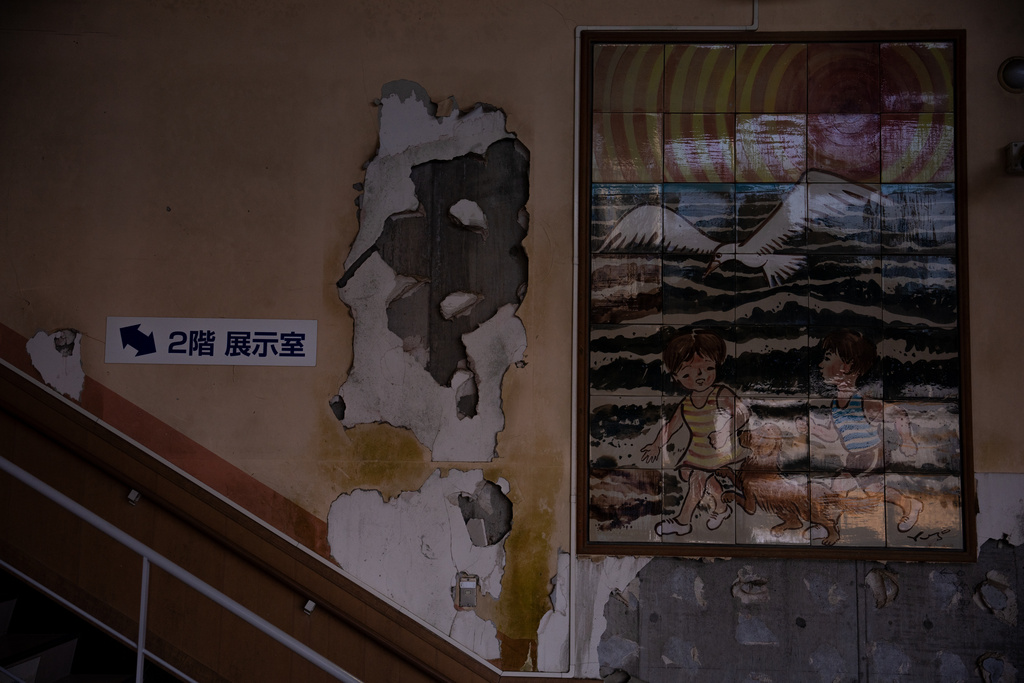 A hallway wall at Ukedo elementary school, damaged by the 2011 tsunami, is seen in Namie, Fukushima Prefecture, Thursday, Feb. 12, 2026. (AP Photo/Louise Delmotte)