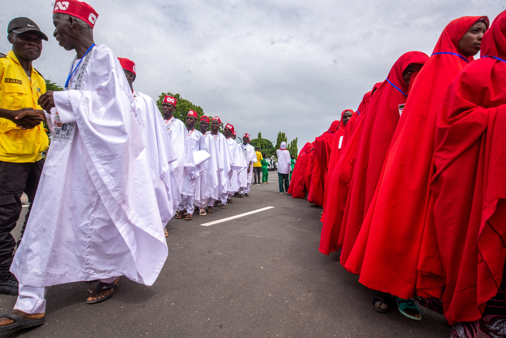 Nigerian brides and grooms arrive for a mass wedding ceremony in Kano, Nigeria, Saturday, Aug. 8, 2026. (AP Photo/Sani Maikatanga)