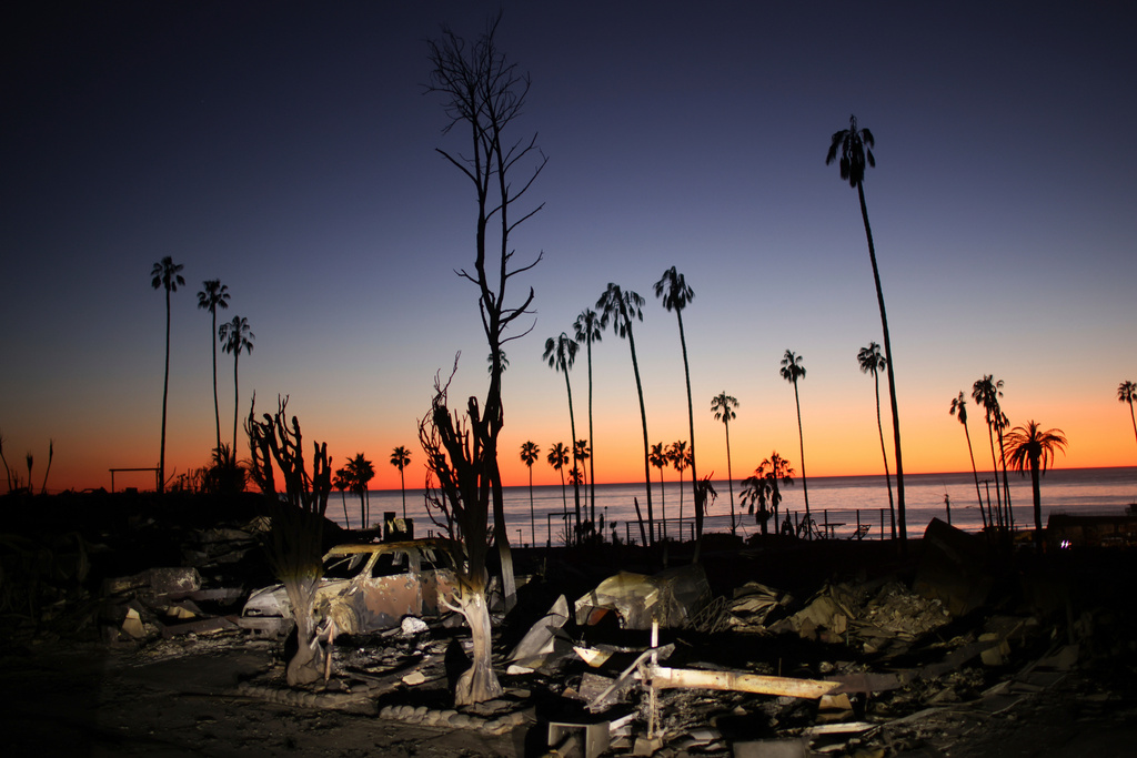 FILE - The devastation of the Palisades Fire is seen at sunset in the Pacific Palisades neighborhood of Los Angeles, Jan. 14, 2025. (AP Photo/Ethan Swope, file)