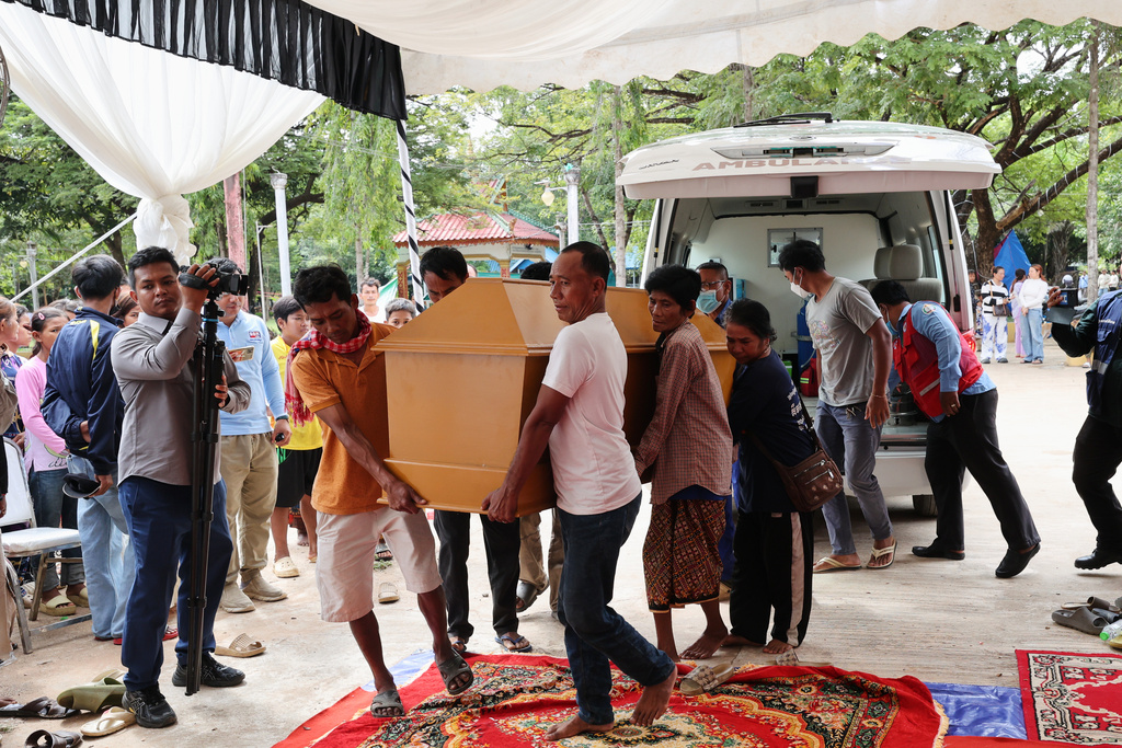 In this photo released by Agence Kampuchea Press (AKP), local residents carry a coffin with the body of Dy Nay body caused by Thai soldiers opened fire on civilians in Prey Chan village, Banteay Meanchey province, on the border with Thailand, at Prey Chan village, Banteay Meanchey province, Cambodia, Thursday, Nov. 13, 2025 (AKP via AP)