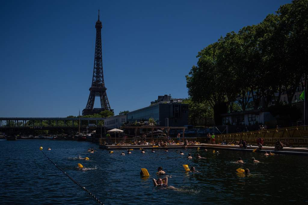 People swim in the Seine River, Saturday, July 4, 2026 in Paris. (AP Photo/Aurelien Morissard)