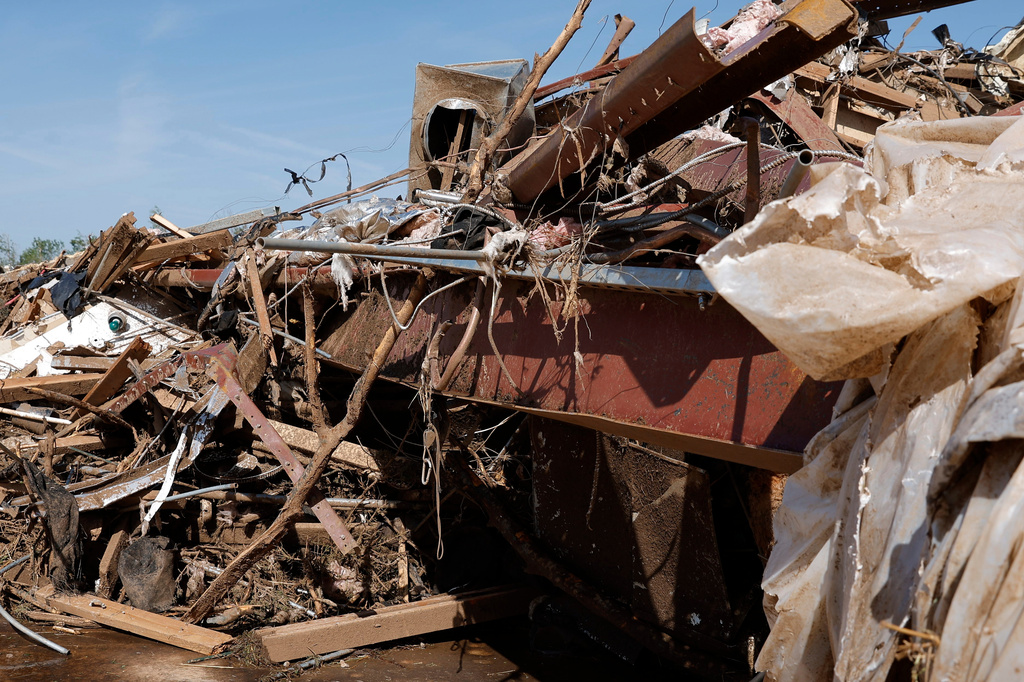 Bent steel beams and debris from a commercial shop is shown Friday, April 24, 2026, in Enid, Okla. (AP Photo/Alonzo Adams)