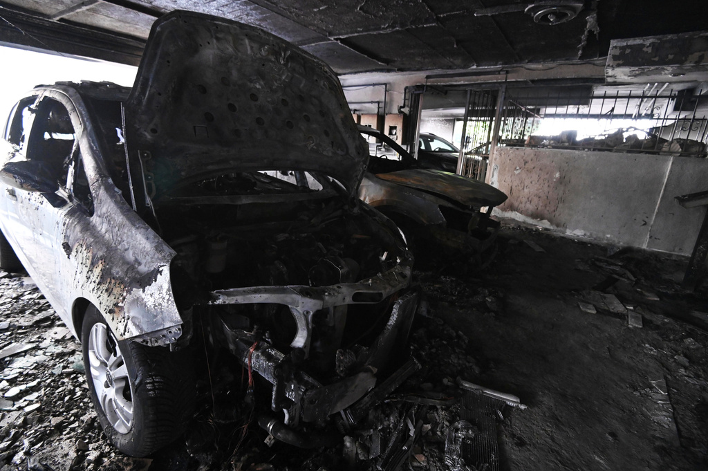 Burned vehicles are seen following firebomb attacks that apparently targeted members of Greece's governing conservative New Democracy party in the northern port city of Thessaloniki, Greece, Wednesday, July 1, 2026. (AP Photo/Giannis Papanikos)