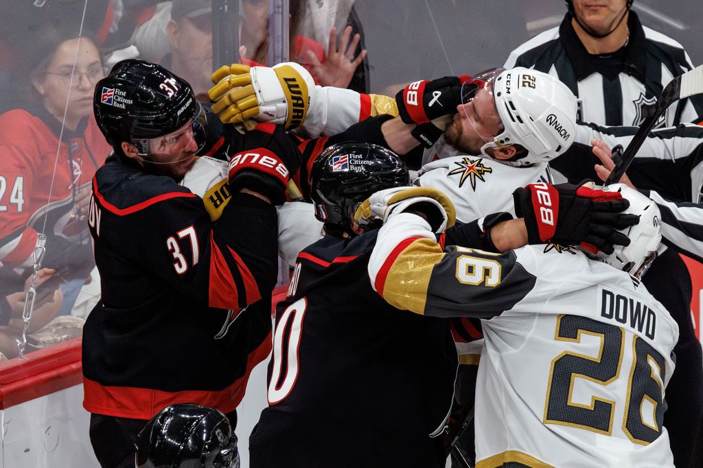 Carolina Hurricanes' Andrei Svechnikov (37) and Sebastian Aho (20) scuffle with Vegas Golden Knights' Cole Smith (22) and Nic Dowd (26) during the second period of Game 2 of the NHL hockey Stanley Cup Final series in Raleigh, N.C., Thursday, June 4, 2026. (AP Photo/Ben McKeown)